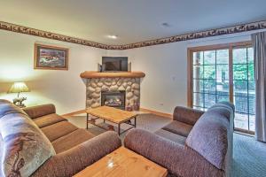 a living room with a couch and a fireplace at Cozy Townhome, Half Mi to Starved Rock State Park! in Utica
