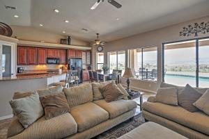 a living room with a couch and a kitchen at Lake Havasu City Retreat with Views and Private Pool! in Lake Havasu City