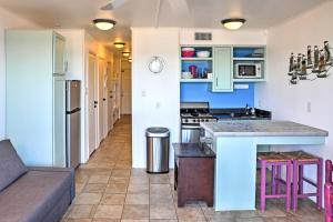 a kitchen with blue cabinets and a counter top at Surfside Sandcastle Suite with Balcony and 2 Pools! in Corpus Christi