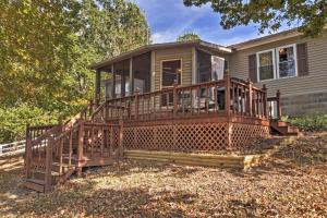 a screened in porch on a house with a deck at Captivating Cadiz Hideaway with Deck on Lake Barkley in Cadiz