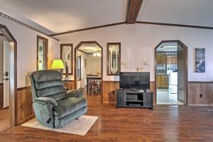 a living room with a chair and a television at Captivating Cadiz Hideaway with Deck on Lake Barkley in Cadiz