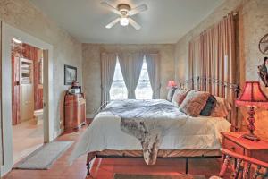 a bedroom with a bed and a ceiling fan at August Schmidt Fredericksburg Cottage with Hot Tub in Fredericksburg