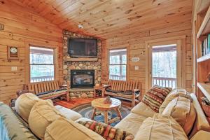 a living room with a couch and a fireplace at Rustic North Conway Cabin Less Than 3 Mi to Cranmore Mtn! in North Conway