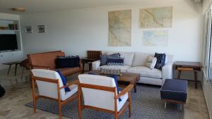 a living room with a couch and a table at Amazing Oceanfront unit on Mansa Beach in Punta del Este