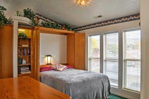 a bedroom with a bed and a book shelf at Sunny La Verkin Studio - 20 Mi to Zion Natl Park! in La Verkin