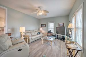 a living room with a couch and a tv at Updated Family Getaway Walk to Sea Haven Beach! in North Topsail Beach
