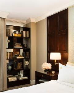 a bedroom with a bed and a book shelf at Rosewood Mansion on Turtle Creek in Dallas