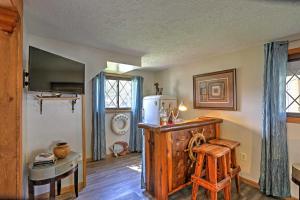 a living room with a wooden table and a refrigerator at Lakeview A-Frame Steps to Marina and Old Field Beach in Lakeview
