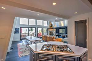 a kitchen and living room with a stove top oven at 10 Mi to Skiing Tahoe City A-Frame Home in Tahoe City
