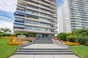 a building with a staircase in front of a garden at Amazing Oceanfront unit on Mansa Beach in Punta del Este