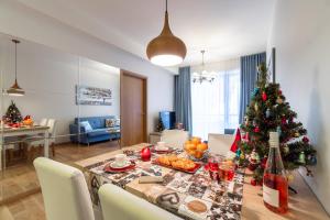 a table with a christmas tree in a living room at Rotermann Square view Apartment in Tallinn