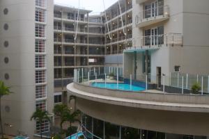an aerial view of a building with a swimming pool at Apartment The Sails in Durban