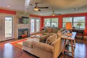 a living room with a couch and a fireplace at Pottsboro Home on 2 Acres with Hot Tub, Near Marina! in Pottsboro