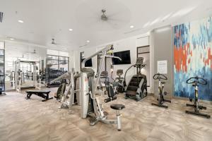 a gym with treadmills and ellipticals in a room at Kasa Arlington Dallas in Arlington