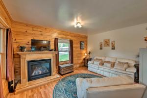 a living room with a couch and a fireplace at Cozy Colorado Cabin with Deck, Grill and River Access! in Buena Vista