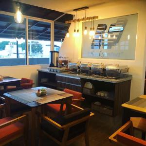 a restaurant with a counter and tables and chairs at Hotel Jiménez in Oaxaca City