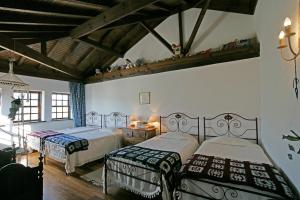 A bed or beds in a room at Casa de Darei