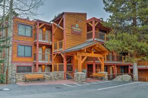 a large wooden building with benches in front of it at SnowDogs Breck Condo with Fireplace Walk to Lifts in Breckenridge