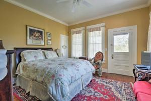 a bedroom with a bed and a couch and a window at Historic Huntington Home with Pond and Flower Gardens! in Zavalla