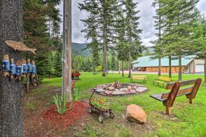 a park with a fire pit and a bench and a tree at Cozy Glacier Park Log Cabin - Best in the West! in Essex
