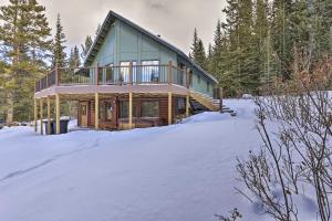 a house in the snow in the woods at Cabin with Hot Tub 3 Mi to Main St Breckenridge! in Breckenridge