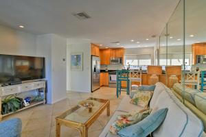 a living room and kitchen with a couch and a table at Siesta Keys Home with Deck Half Mile to Turtle Beach in Siesta Key
