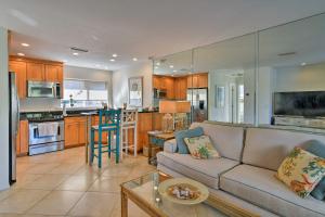 a living room with a couch and a kitchen at Siesta Keys Home with Deck Half Mile to Turtle Beach in Siesta Key
