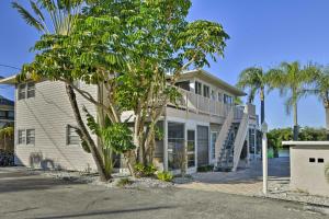 a white house with palm trees in front of it at Siesta Keys Home with Deck Half Mile to Turtle Beach in Siesta Key
