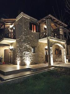 a stone house at night with lights at AELIA HOME in Synikia Mesi Trikalon