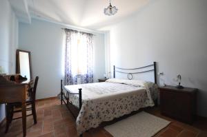a bedroom with a bed and a dresser and a window at Casa Cardarella in Beroide