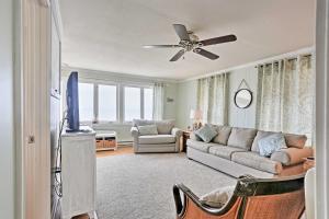 a living room with a couch and a flat screen tv at Waterfront Oak Harbor Home on Lake Erie with Views! in Sand Beach