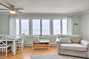 a living room with a couch and a table and chairs at Waterfront Oak Harbor Home on Lake Erie with Views! in Sand Beach