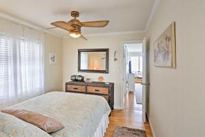 a bedroom with a bed and a ceiling fan at Waterfront Oak Harbor Home on Lake Erie with Views! in Sand Beach
