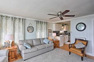 a living room with a couch and a clock on the wall at Waterfront Oak Harbor Home on Lake Erie with Views! in Sand Beach +16 photos