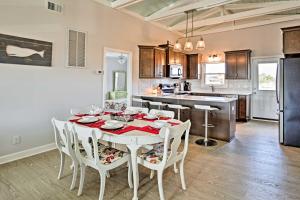 a kitchen and dining room with a white table and chairs at Holden Beach Vacation Rental Steps to Shore! in Holden Beach