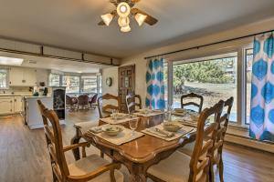 a dining room with a table and chairs and a kitchen at Spacious Colorado Retreat with Deck and Mountain Views in Estes Park
