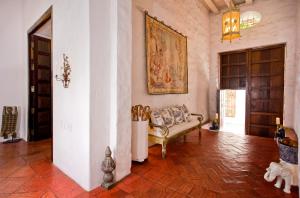 a living room filled with furniture and a painting on the wall at Hotel Casa Quero in Cartagena de Indias