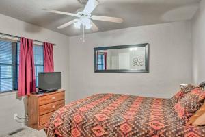 a bedroom with a bed and a tv and a ceiling fan at Ruidoso Lil Mountain Getaway - Links Golf Course in Ruidoso