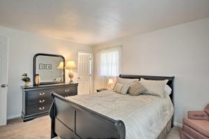 a bedroom with a large bed and a mirror at Gorgeous Cape Coral Duplex Home with Modern Interior in Cape Coral