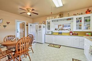 a kitchen with white cabinets and a table and chairs at Peaceful Retreat on 1 Acre with Panoramic Mtn Views! in Leadore