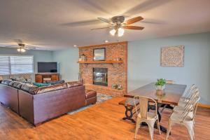 a living room with a couch and a table and a fireplace at Gorgeous Waldo Home with Dock on Santa Fe Lake! in Waldo