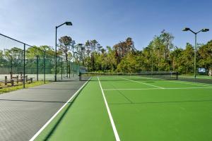 a tennis court with two tennis nets on it at Hilton Head Resort Condo with Pool and Beach Access in Hilton Head Island