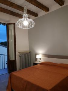 a bedroom with a bed and a chandelier at Affittacamere Ramazzini in Florence