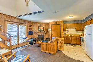 a kitchen and living room with a couch and a refrigerator at Clearwater Lake Getaway with Shared Pool and Boat Dock in Annandale