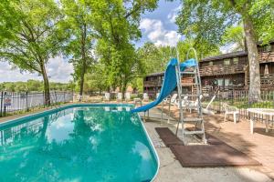 a slide in a swimming pool with a playground at Clearwater Lake Getaway with Shared Pool and Boat Dock in Annandale