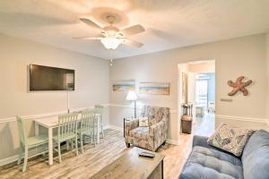 a living room with a couch and a table at Garden City Condo with Pool Access - Walk to Beach! in Myrtle Beach