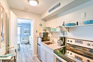 a kitchen with a sink and a stove at Garden City Condo with Pool Access - Walk to Beach! in Myrtle Beach