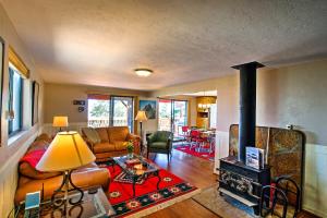 a living room with a couch and a fireplace at Spacious Cabin with Deck, Mountain Views, Fire Pit! in Prescott