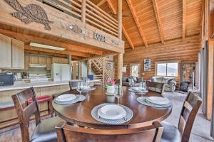 a dining room with a table and chairs and a kitchen at Spacious Hilltop Cabin with Deck and Scenic Views! in Eden