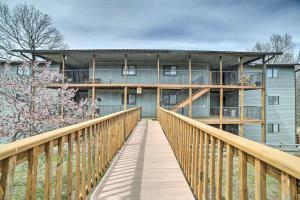a wooden bridge leading to a building with a balcony at Branson Condo with Views 2 Mi to Silver Dollar City in Branson West